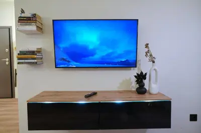 a flat screen tv hanging on a wall at P Faliro Riviera Suite in Athens