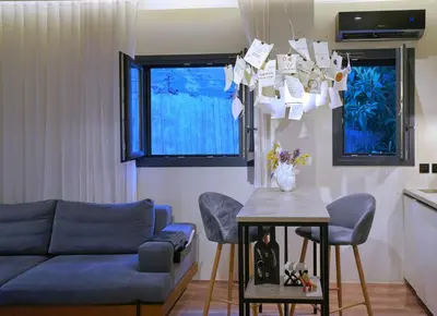 a living room with a blue couch and a table at P Faliro Riviera Suite in Athens