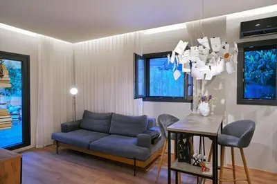 a living room with a couch and a table at P Faliro Riviera Suite in Athens
