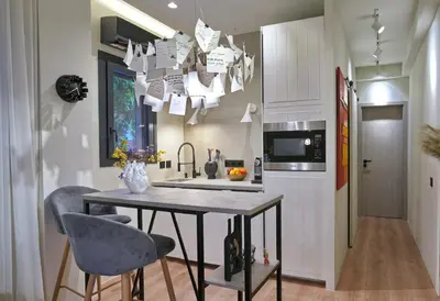 a kitchen with a table and chairs and a microwave at P Faliro Riviera Suite in Athens