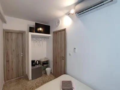 a bedroom with a bed and a closet and a door at PURE URBAN ACROPOLIS METRO PETRALONA in Athens