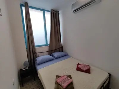 a small bedroom with a bed and a window at PURE URBAN ACROPOLIS METRO PETRALONA in Athens