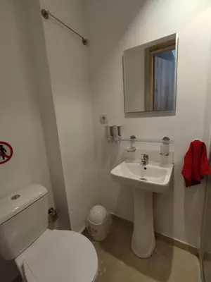 a white bathroom with a toilet and a sink at PURE URBAN ACROPOLIS METRO PETRALONA in Athens