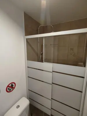 a white bathroom with a shower and a toilet at PURE URBAN ACROPOLIS METRO PETRALONA in Athens