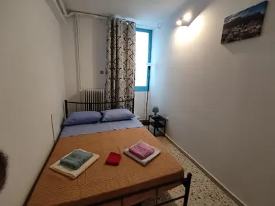 a bedroom with a bed with two pillows on it at PURE URBAN ACROPOLIS METRO PETRALONA in Athens