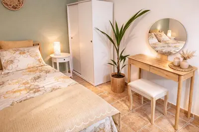 a bedroom with a bed and a desk and a mirror at Cozy apartment in Peania (near Airport) in Paianía
