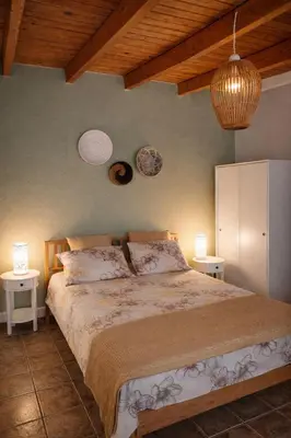 a bedroom with a large bed with two night stands at Cozy apartment in Peania (near Airport) in Paianía