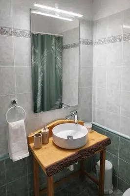 a bathroom with a sink and a mirror at Cozy apartment in Peania (near Airport) in Paianía