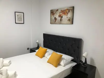 a bedroom with a bed with two yellow pillows at Our little 1 in Athens