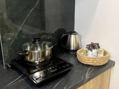 a stove with a pot and a basket on a counter at Our little 1 in Athens