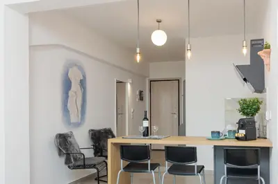 a kitchen with a table and chairs in a room at Nereid Apartment in Athens