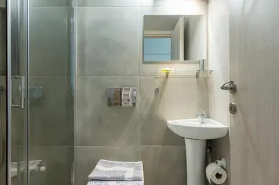 a bathroom with a shower and a sink at Nereid Apartment in Athens
