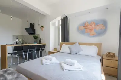 a bedroom with a bed with white towels on it at Nereid Apartment in Athens