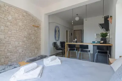 a bedroom with a bed with two white towels on it at Nereid Apartment in Athens