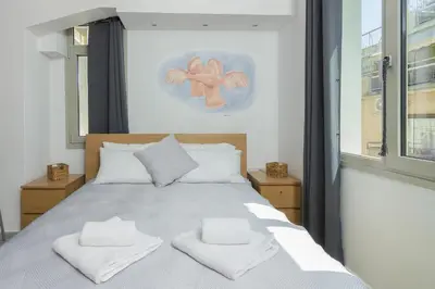 a bedroom with a bed with two towels on it at Nereid Apartment in Athens