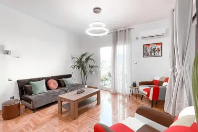 a living room with a couch and a table at Amazing View 2BR Apartment | Heart of Athens in Athens