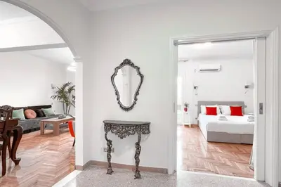 a living room with a table and a bed at Amazing View 2BR Apartment | Heart of Athens in Athens
