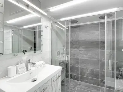 a bathroom with a shower and a sink and a mirror at Amazing View 2BR Apartment | Heart of Athens in Athens