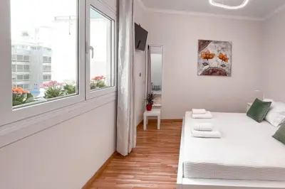 a white room with a bed and a window at Amazing View 2BR Apartment | Heart of Athens in Athens