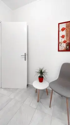 a room with a chair and a table and a door at Amazing View 2BR Apartment | Heart of Athens in Athens