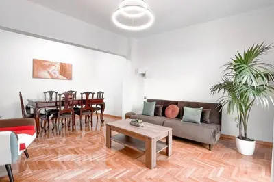 a living room with a couch and a table at Amazing View 2BR Apartment | Heart of Athens in Athens