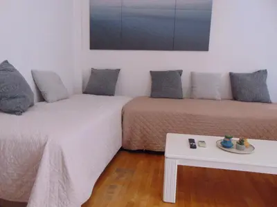 a room with two beds and a coffee table at Lovely equipped apartment in Kallithea Athens in Athens