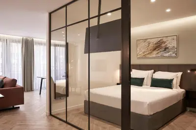 a bedroom with a bed with a glass wall at Hestia - Dimitressa 4 in Athens