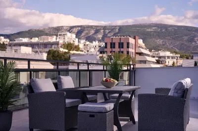 a patio with a table and chairs on a balcony at Hestia - Dimitressa 4 in Athens