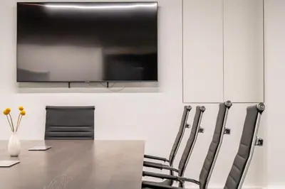 a conference room with a table and chairs and a flat screen tv at Hestia - Dimitressa 4 in Athens