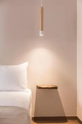 a bedroom with a bed and a table with a lamp at Luxury Apartment with Jacuzzi Close to Acropolis - Living Stone Zircon in Athens