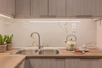 a kitchen with a sink and a tea kettle on a counter at Luxury Apartment with Jacuzzi Close to Acropolis - Living Stone Zircon in Athens