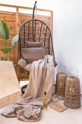 a table with two wine glasses and a chair at Luxury Apartment with Jacuzzi Close to Acropolis - Living Stone Zircon in Athens