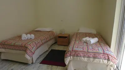 two beds sitting next to each other in a room at Modern apartment near Acropolis peaceful location. in Athens