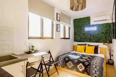a small bedroom with a bed and a desk at Downtown 22sqm Green Nest King-Size Bed in Athens