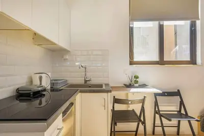 a kitchen with two chairs and a counter top at Downtown 22sqm Green Nest King-Size Bed in Athens
