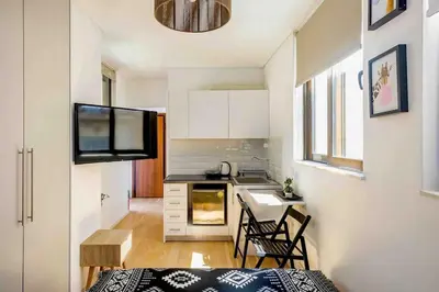 a small kitchen with a table and chairs in a room at Downtown 22sqm Green Nest King-Size Bed in Athens
