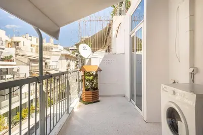 a balcony with a washer and dryer in a house at Downtown 22sqm Green Nest King-Size Bed in Athens