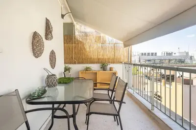 a balcony with a glass table and chairs at Downtown 22sqm Green Nest King-Size Bed in Athens
