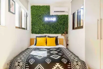 a bedroom with a bed and a green wall at Downtown 22sqm Green Nest King-Size Bed in Athens