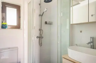 a bathroom with a shower and a sink at Downtown 22sqm Green Nest King-Size Bed in Athens