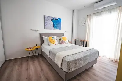 a bedroom with a large bed and a window at Athena B&B in Athens