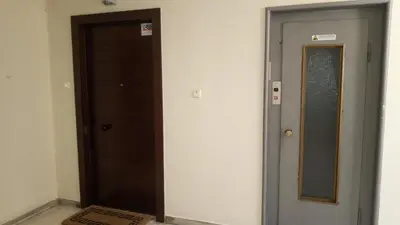 a hallway with two elevators and a door at Parthenon and Syntagma square view apartment in Athens
