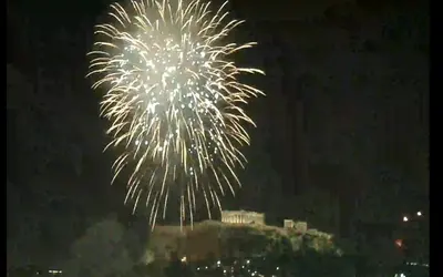 a firework display in a city at night at Parthenon and Syntagma square view apartment in Athens