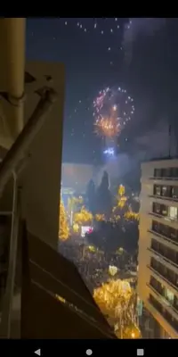 a view of a city with fireworks in the sky at Parthenon and Syntagma square view apartment in Athens