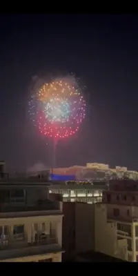 a firework in the sky over a city at night at Parthenon and Syntagma square view apartment in Athens