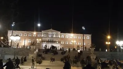 a large white building with people standing in front of it at Parthenon and Syntagma square view apartment in Athens