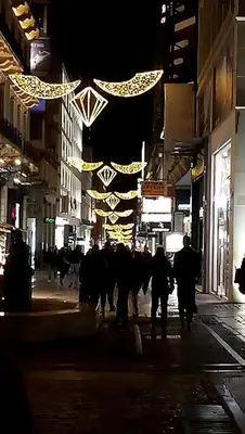 a group of people walking down a street at night at Parthenon and Syntagma square view apartment in Athens