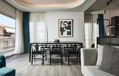 a living room with a dining room table and a couch at Acropolis Panorama Residence in Athens