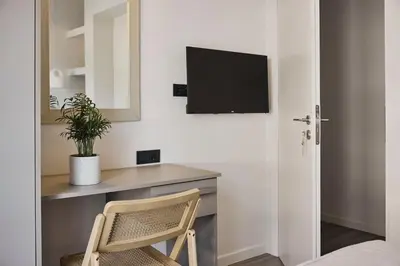 a room with a desk with a television and a chair at Acropolis Panorama Residence in Athens