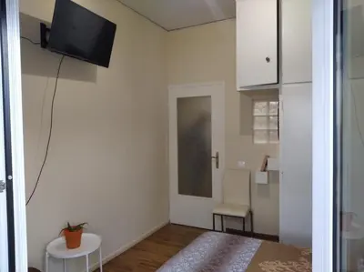 a living room with a tv on the wall at Kerameikos residence in Athens